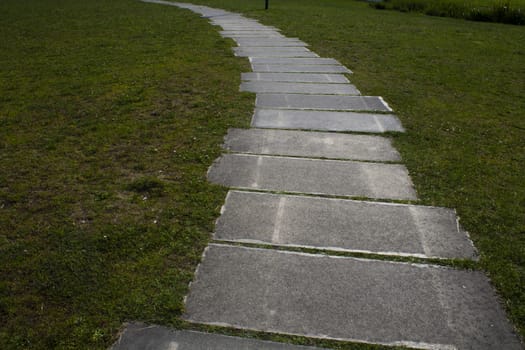 garden concrete tiles the road is the path with lawn