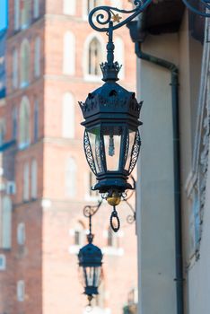 closeup vintage wrought iron lantern on the wall of a house in a European city