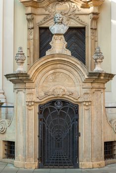 Beautiful door to the building with a bust at the top in a European city close up