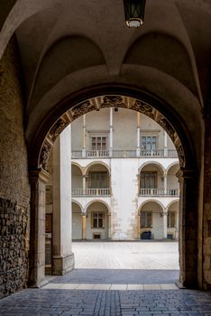 Krakow, Poland - August 13, 2017: beautiful architectural arch and a view of the columns of the royal palace in the castle of Wawel