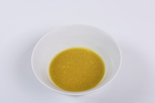 Creamy broccoli soup on a white background