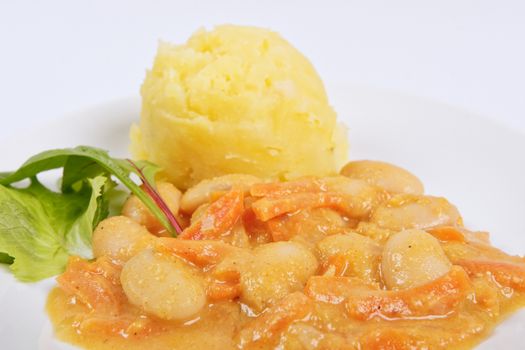 Beans with carrots and potatoes on a white background