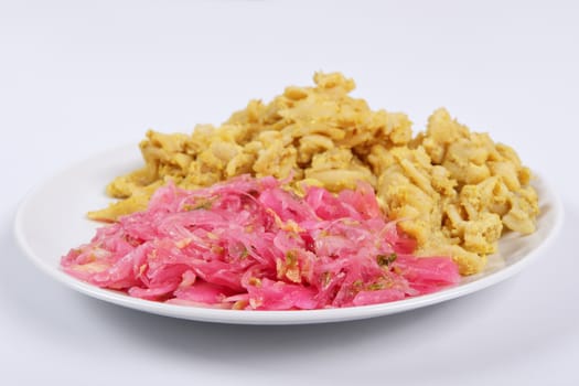 Whole-grain pasta with tofu on a white background