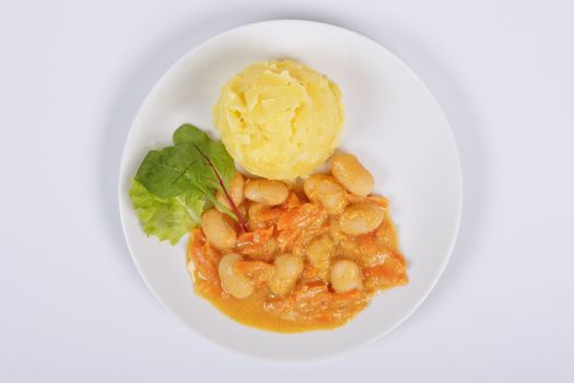 Beans with carrots and potatoes on a white background