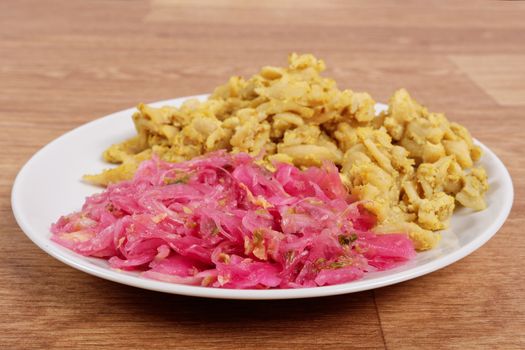 Whole-grain pasta with tofu on a wooden table