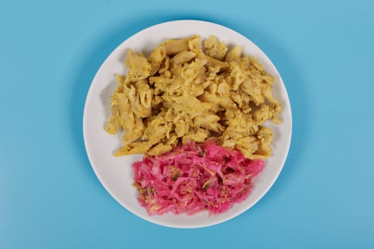 Whole-grain pasta with tofu on a blue background