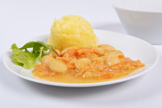 Beans with carrots and potatoes on a white background