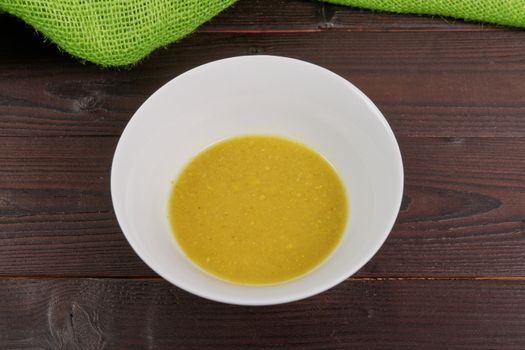 Creamy broccoli soup on a wooden table