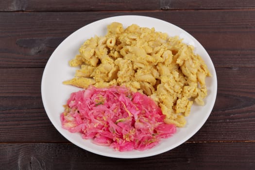 Whole-grain pasta with tofu on a wooden table