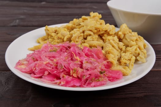 Whole-grain pasta with tofu on a wooden table