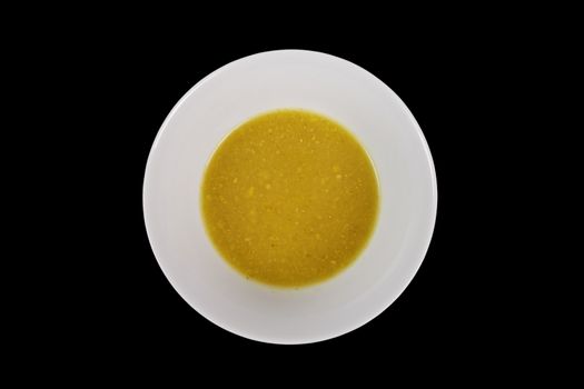 Creamy broccoli soup on a black background