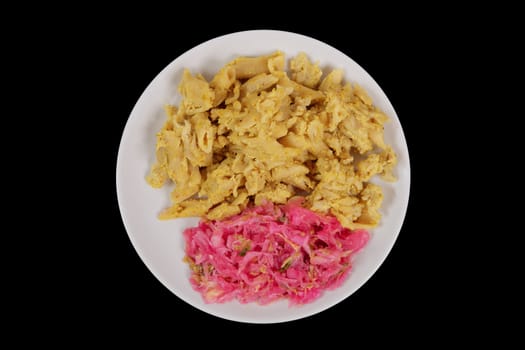 Whole-grain pasta with tofu on a black background