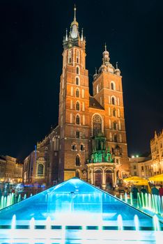 the central square of Krakow at night, view of the Church of Mary