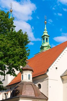 Roofs and domes of the Catholic church in a European city against the sky