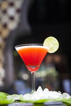  Cocktail on the background of the bar. Red alcoholic cocktail in a traditional glass. Place to write a recipe