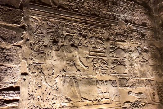 Egyptian hieroglyphs and drawings on the walls and columns. Egyptian language, The life of ancient gods and people in hieroglyphics and drawings