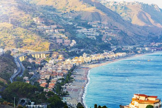 Travel to Sicily, Italy - above view of Letojanni resort town of coast of Ionian Sea from Taormina city in summer day