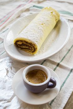 breakfast with Swiss roll with chocolate filling and espresso