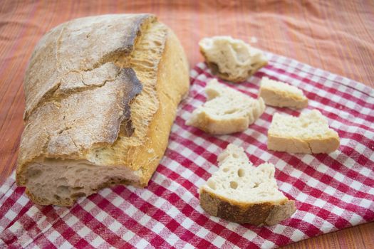 loaf of french bread with near some small pieces of it