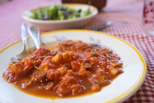 plate of tomato sauce with stir fried herbs and capers