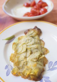 gilthead fillet in potato crust on a set table