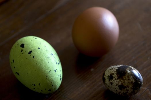 hen and quail eggs with colored easter egg