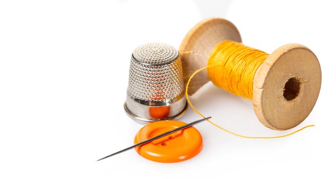 spool of thread and buttons on white isolated background