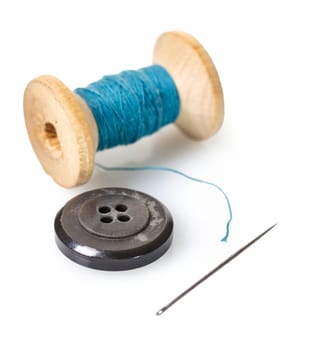 spool of thread and buttons on white isolated background