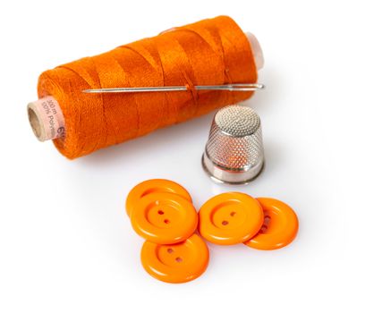 spool of thread and buttons on white isolated background