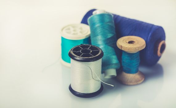 coils with colorful thread on white background