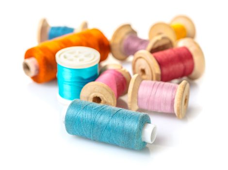 coils with colorful thread on white isolated background