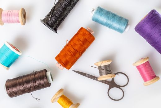 coils with colorful thread on white background