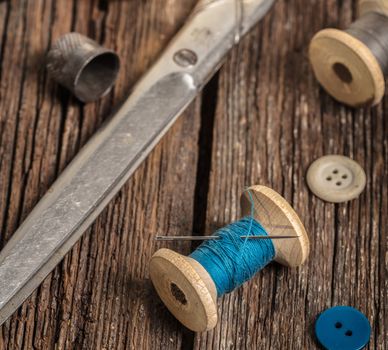 thread and sewing accessories on a wooden background