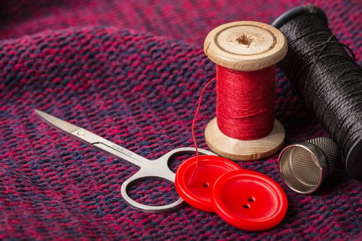 items for sewing against the background of knitted fabric