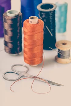 coils with colorful thread on white background