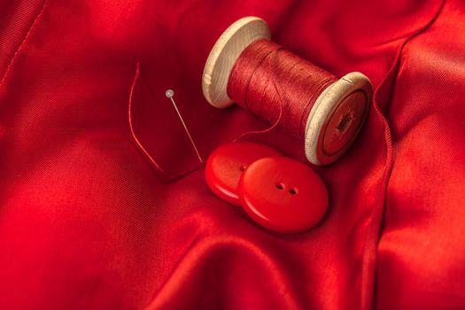 red thread with buttons on the background of lining fabric
