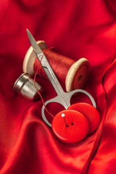 red thread with buttons on the background of lining fabric