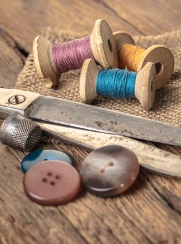 scissors and sewing accessories on a wooden background