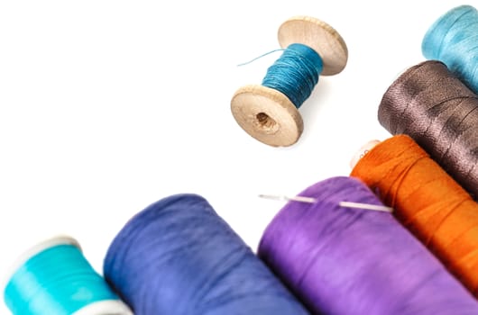 spools of colorful threads on a white background