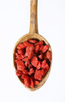 spoon of healthy goji berries on white background