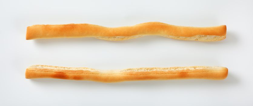two crispy bread sticks on white background