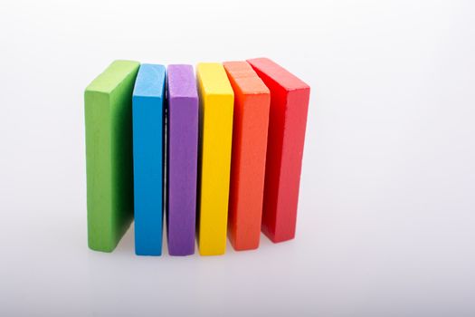 Colorful Domino Blocks in a line on a white background