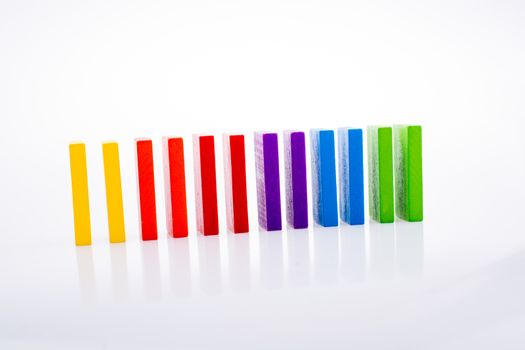 Colorful Domino Blocks in a line on a white background