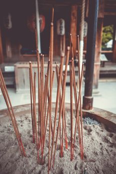 incense sticks in Kinkaku-ji golden temple, Kyoto, Japan