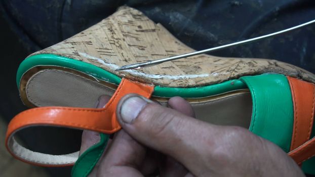 the shoemaker at work.The process of repairing shoes in workshop.