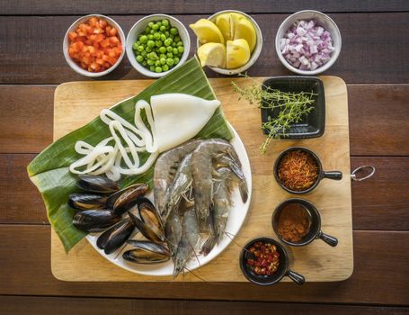 Raw seafood on plate, healthy food, prawn, clam squid.