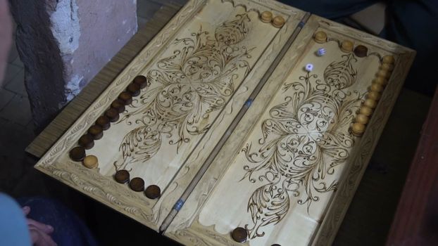 men playing backgammon,wooden Board ,roll the dice