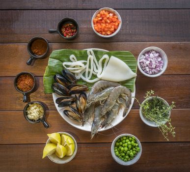 Overhead shot of Raw seafood on plate, healthy food, prawn, clam squid.