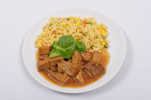 Tempeh with tomato sauce and millets on a white background