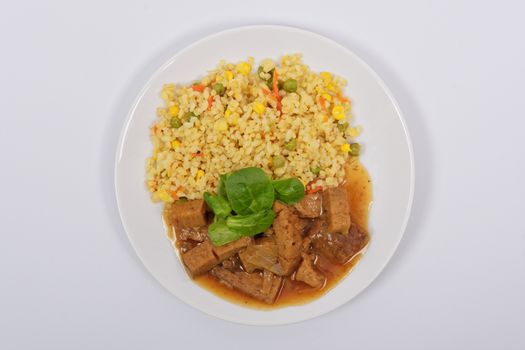 Tempeh with tomato sauce and millets on a white background